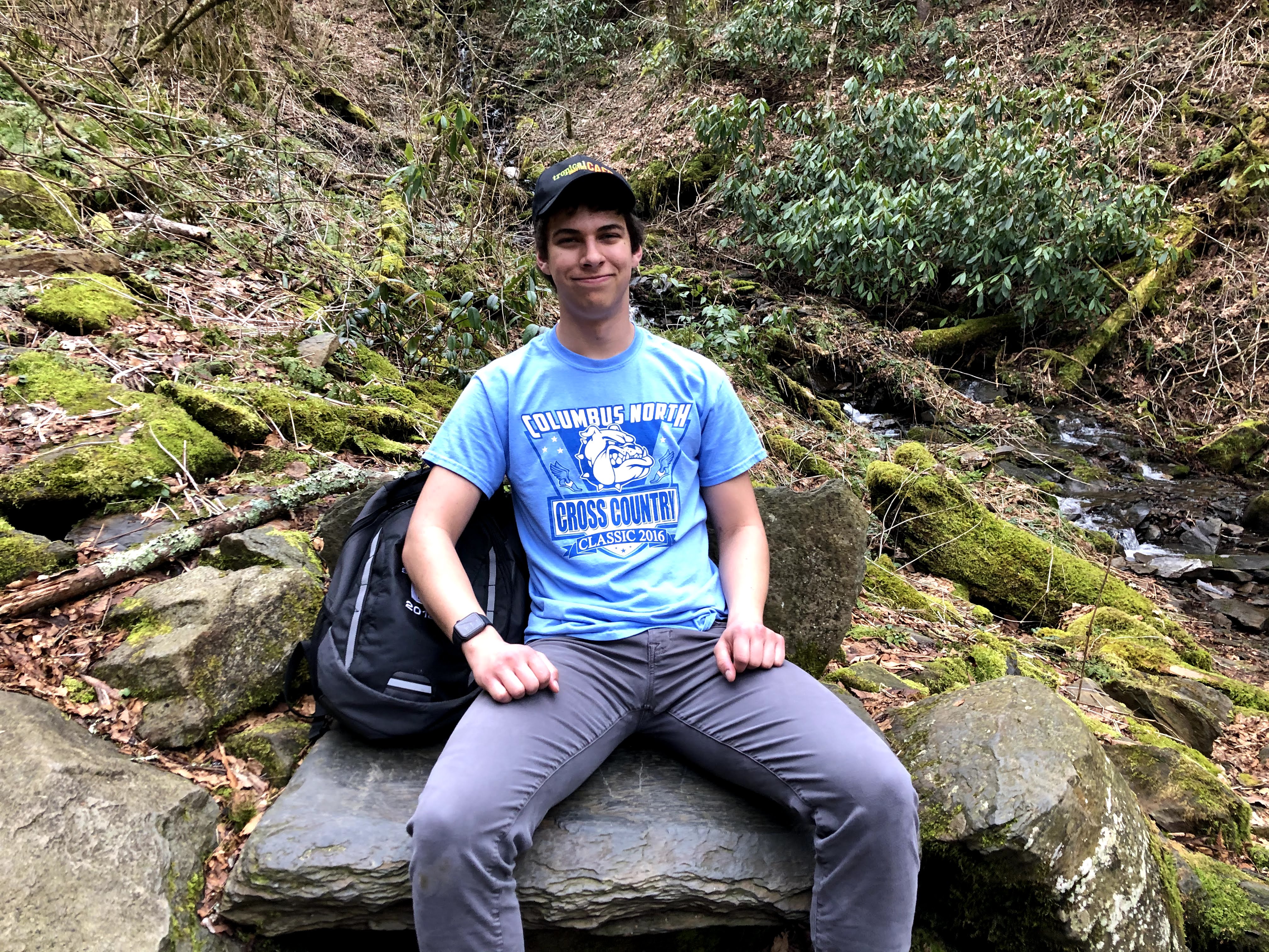 Jarrett rests on a rock during a hike