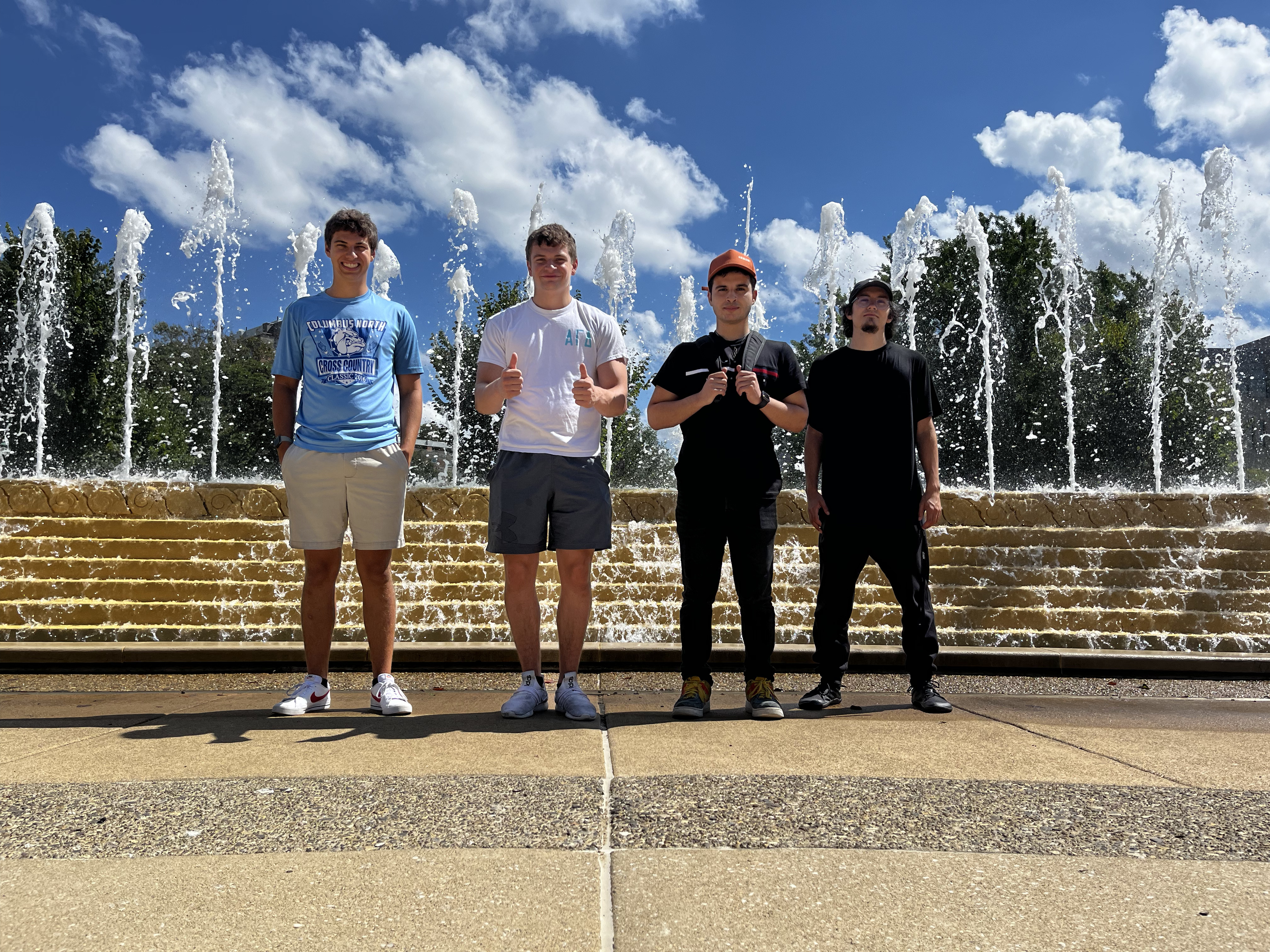 Jarrett poses with his capstone group in front of a fountain